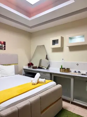 a bedroom with a bed and a desk with a printer at Habitaciónes suite 10 min del Monumento & Agora Mall in Santiago de los Caballeros
