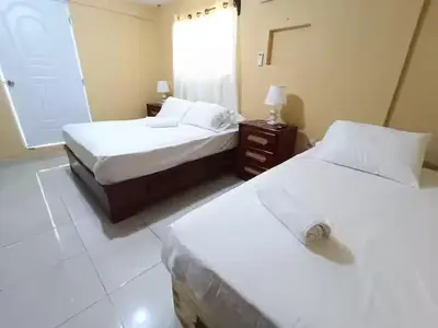 a hotel room with two beds and a window at Ideal para Dormir in Los Patos