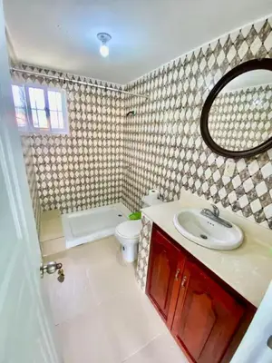 a bathroom with a sink and a toilet and a mirror at Ideal para Dormir in Los Patos