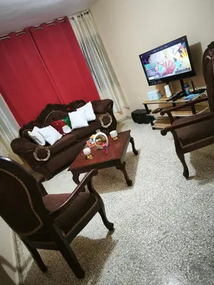 a living room with a couch and chairs and a tv at Cozy and functional space in SJM