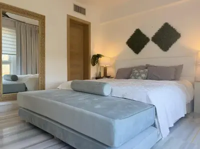 a bedroom with a large bed and a large mirror at Seawinds Beachfront -Top Floor Less Mosquitos -Full Security in Cabarete