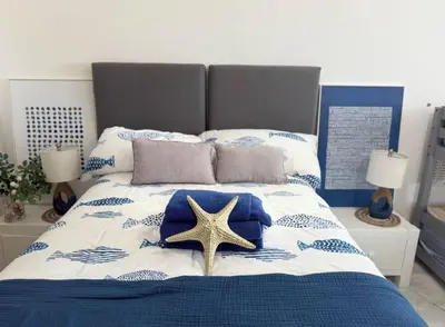 a bedroom with a bed with a starfish on it at Seawinds Beachfront -Top Floor Less Mosquitos -Full Security in Cabarete