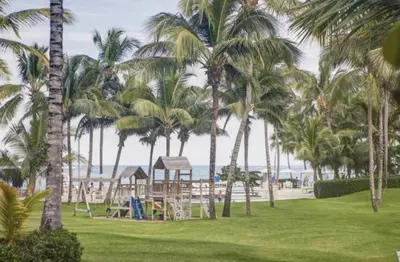 a park with palm trees and a playground at Seawinds Beachfront -Top Floor Less Mosquitos -Full Security in Cabarete