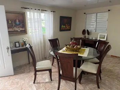 a dining room with a glass table and chairs at Excelente lugar en montecristi muy céntrico tu mejor opción in San Fernando de Monte Cristi