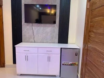 a white cabinet with a television on a wall at Villa Palmera Barahona, Dream Getaway in Santa Cruz de Barahona
