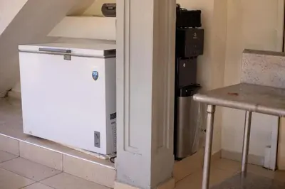a small white refrigerator next to a trash can at Villa Palmera Barahona, Dream Getaway in Santa Cruz de Barahona