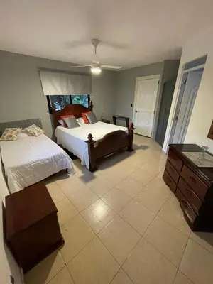 a bedroom with two beds and a dresser at Apartamento en el Corazón de Las Terrenas in Las Terrenas
