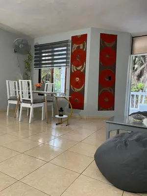 a living room with a table and chairs at Apartamento en el Corazón de Las Terrenas in Las Terrenas