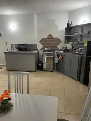 a kitchen with a stove and a table in it at Apartamento en el Corazón de Las Terrenas in Las Terrenas
