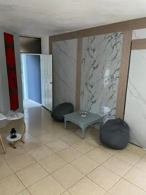 a living room with two chairs and a table at Apartamento en el Corazón de Las Terrenas in Las Terrenas