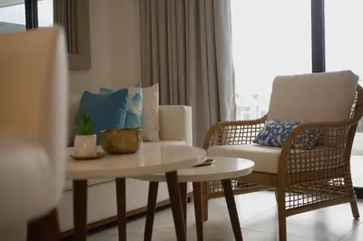 a living room with two chairs and a table at 1BRM Infinity Homes Punta Cana in Punta Cana