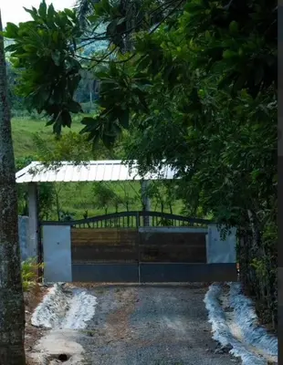 a bench in front of a gate in a park at Villa María 2 in Bonao