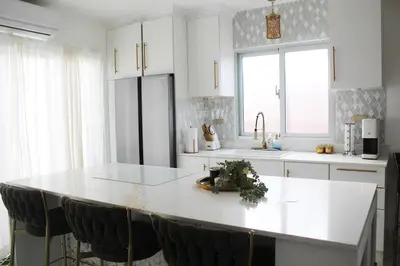 a kitchen with a large white island in the middle at Casaè Rojas Presents Golden Oasis in Punta Cana