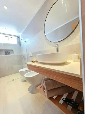 a bathroom with a sink and two toilets and a mirror at Estrella Garden Shaula 104 New Modern Apartment in La Laguna