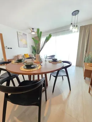 a dining table and chairs in a living room at Estrella Garden Shaula 104 New Modern Apartment in La Laguna