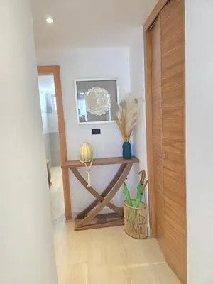 a hallway with a table with a plant on it at Estrella Garden Shaula 104 New Modern Apartment in La Laguna