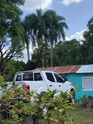 a white truck parked in front of a house at Casa de Campo Vive in Ensanche Savica de Mendoza