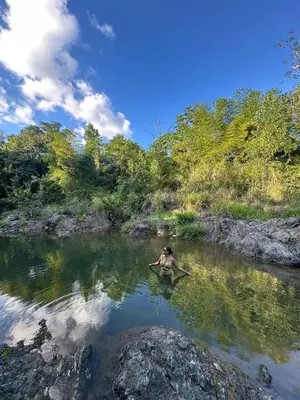 a person in the water in a river at Casita de Campo VIVE in Pedro Brand