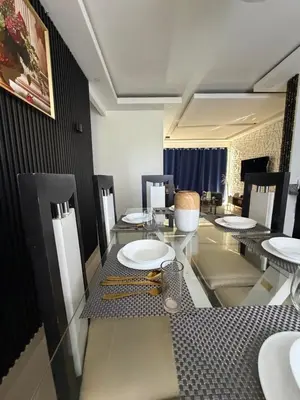 a dining room with a table and chairs with plates at Vacaciones809 in Juan López