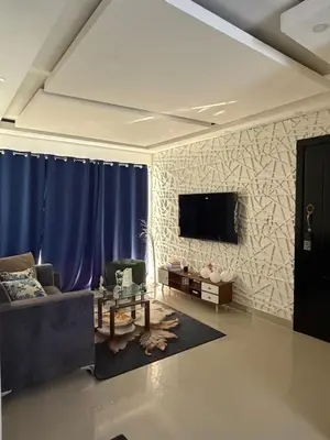 a living room with a couch and a tv on a wall at Vacaciones809 in Juan López