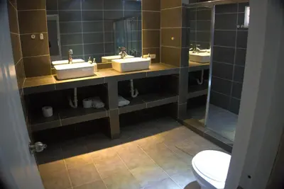 a bathroom with three sinks and a toilet at Villa Emili in Las Terrenas