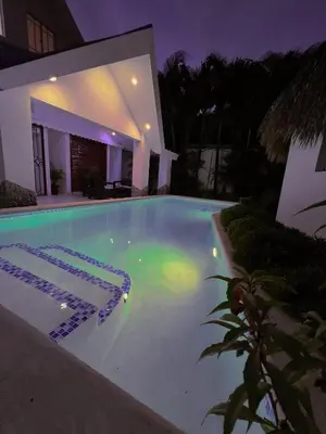 a swimming pool in front of a house at night at Villa Emili in Las Terrenas