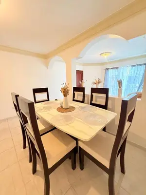 a dining room with a table and chairs at Residencial Marvin I Apartamento 1A in Santiago de los Caballeros