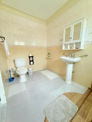 a bathroom with a toilet and a sink at Residencial Marvin I Apartamento 1A in Santiago de los Caballeros