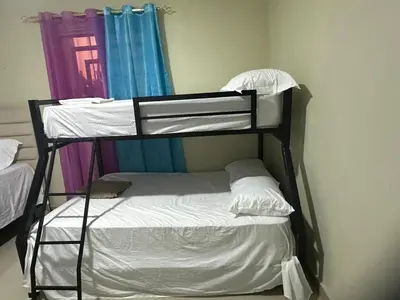 a bunk bed in a room next to a window at Rincón Paraíso Cheché in Dajabón