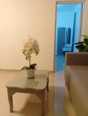 a living room with a table with a flower on it at Sol y Arena in Pedernales