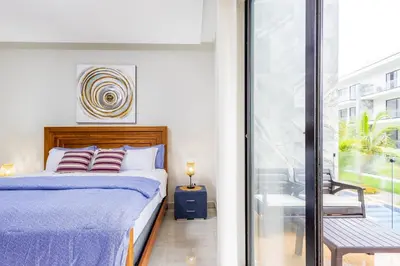 a bedroom with a bed and a balcony at Quiet 1-Bedroom Apartment with Pool View in Gated Bávaro Residence in Punta Cana