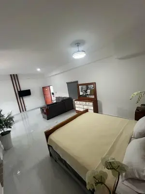 a bedroom with a large bed and a living room at Hotel Altos de la Montaña in Colonia Japonesa