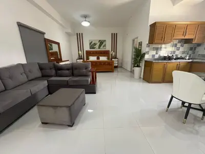 a living room with a couch and a table and a kitchen at Hotel Altos de la Montaña in Colonia Japonesa