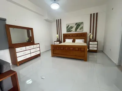 a bedroom with a bed and two dressers and a mirror at Hotel Altos de la Montaña in Colonia Japonesa