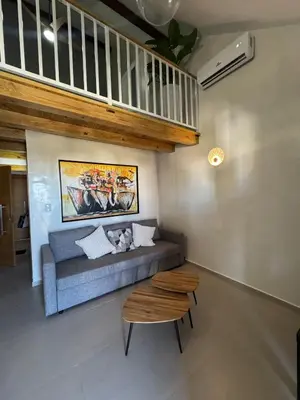 a living room with a couch and a table at Apartment bayahibe in Bayahibe