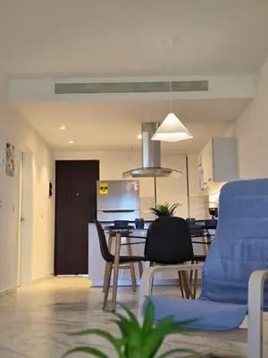 a kitchen and living room with a table and chairs at Exclusive 2BR Apartment Punta Cana in Punta Cana