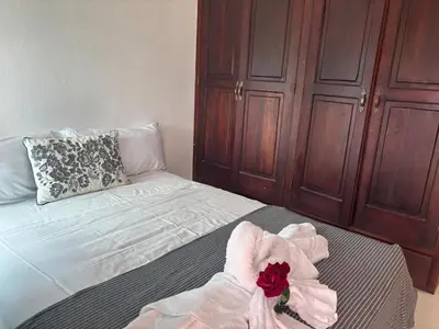 a bedroom with a bed with a flower on it at Casa Bonita by Mireya in Bayahibe