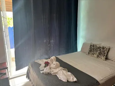 a room with a bed with a towel animal on it at Casa Bonita by Mireya in Bayahibe