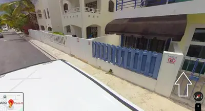 a building with a blue fence next to a street at Casa Bonita by Mireya in Bayahibe