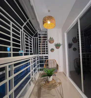 a balcony with a chair and a potted plant at San Isidro Urban Suite in Juan López