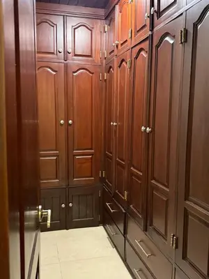 a locker room with wooden cabinets and a door at Getaway paradise in Los Mameyes