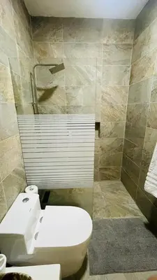 a bathroom with a toilet and a shower at oceanfront apartment in La Puntica de Juan Dolio
