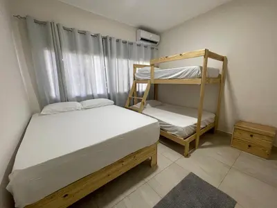 a bedroom with two bunk beds and a window at oceanfront apartment in La Puntica de Juan Dolio