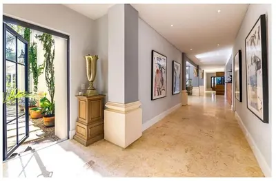 a hallway with a vase on a column in a house at Luxury Awaits at Casa de Campo A Stunning Five-Bedroom Retreat in La Romana