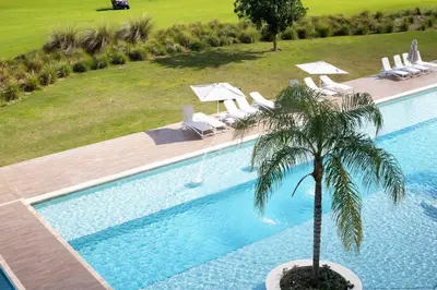 an overhead view of a swimming pool with a palm tree at Spacious 3BR Residence in Punta Cana by Infinity Homes in Punta Cana