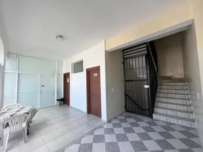 an empty hallway with stairs and a door and a stair case at Plaza Achim 6B, Modern APT 250m from Sosua beach! in Sosúa