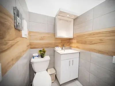 a small bathroom with a toilet and a sink at Plaza Achim 6B, Modern APT 250m from Sosua beach! in Sosúa