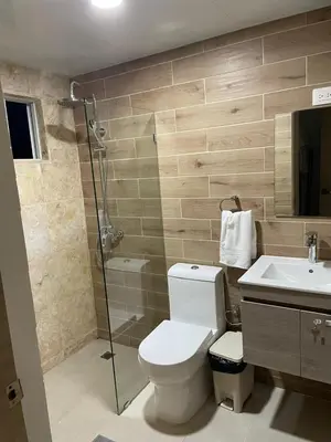 a bathroom with a toilet and a shower and a sink at 3 bedroom apartment in Armonía Las Terrenas in Las Terrenas