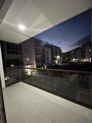 a building with a view of a city at night at 3 bedroom apartment in Armonía Las Terrenas in Las Terrenas