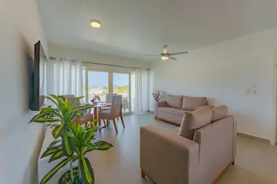 a living room with a couch and a table at Prime Apartment with Fast Internet & Washer in SOV in Sosúa